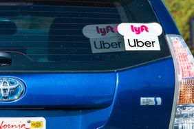 Lyft and Uber stickers seen on a Toyota. 