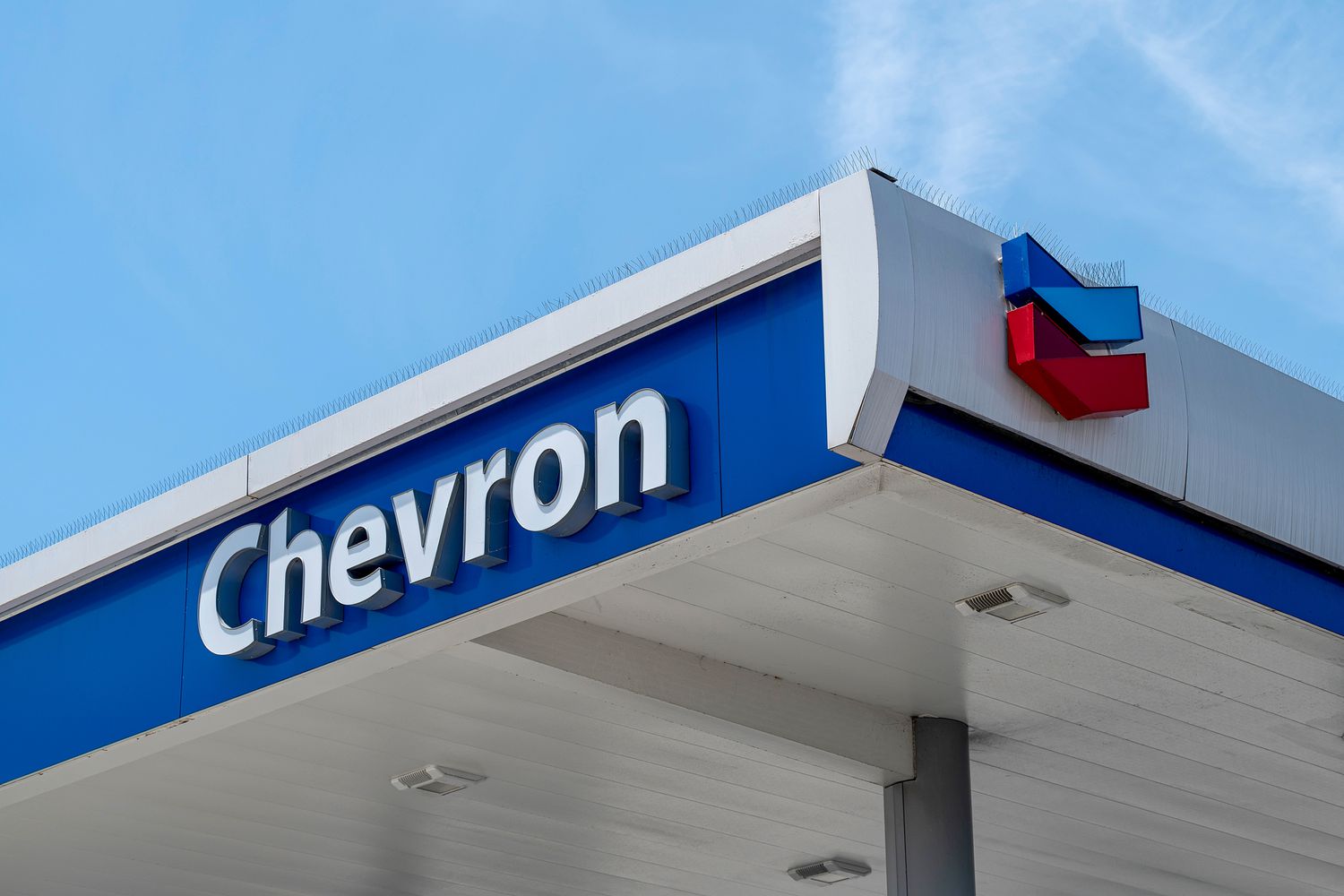 The word "Chevron" and the company's red and blue logo is on the roof of a gas station.
