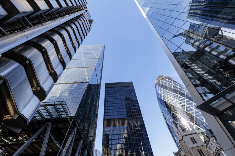 Looking up at futuristic city skyscrapers in London