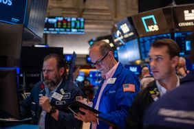 Traders work on the floor of the New York Stock Exchange (NYSE) on May 13, 2025 in New York City. 