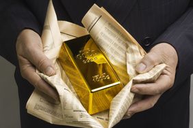 Hands holding a gold bar