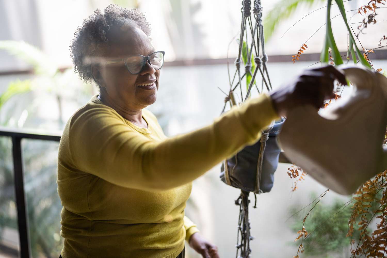 Woman contemplates whether she should refinance her home or get a reverse mortgage while gardening