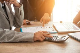 two accountants at desk looking at finances