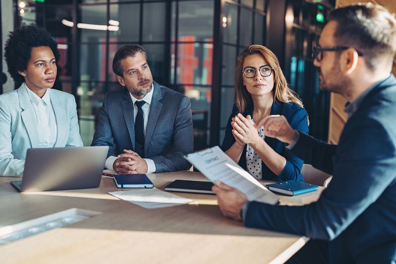 People sitting around a table talking to a financial advisor