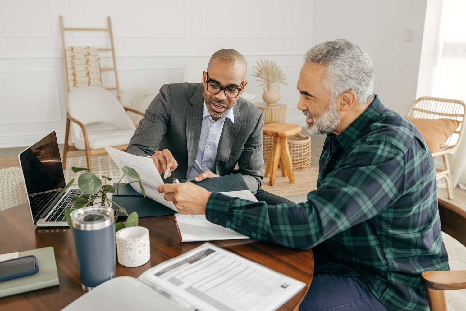 Two men discuss paperwork