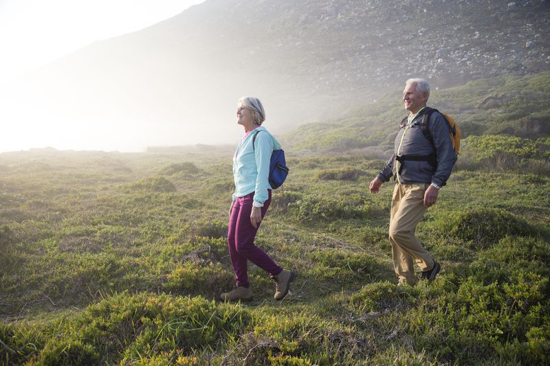 An older couple takes a hike.