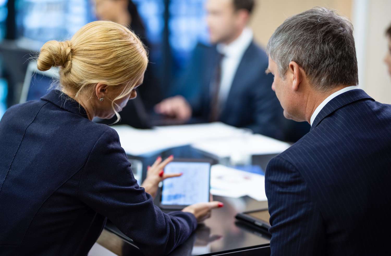 Colleagues in a business meeting with a tablet