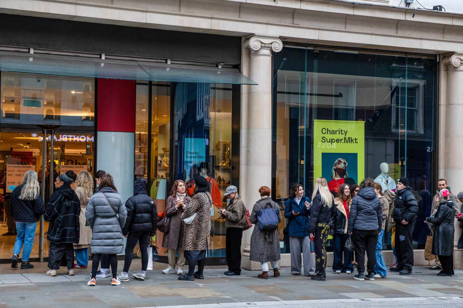 Customers queue in front of charity supermarket popup 
