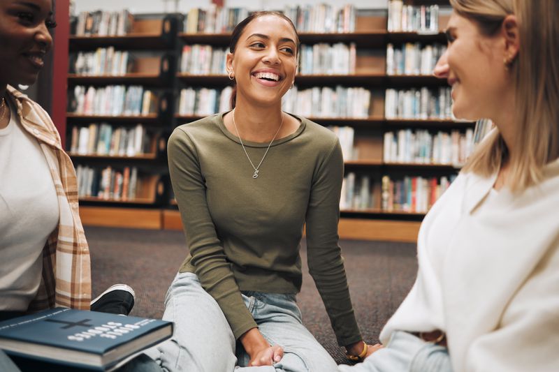 Friends have a book discussion in a local bookshop.