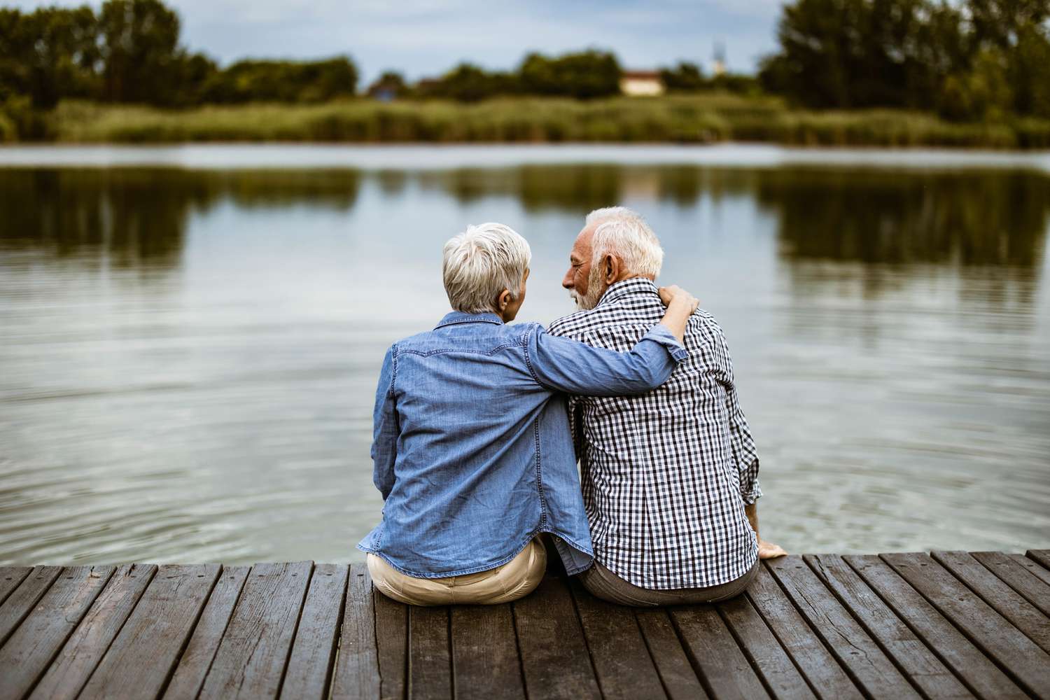 Older couple sitting by lake