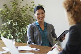 A woman meets with a clients.
