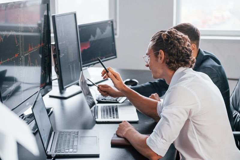 Stockbrokers choosing securities to do speculative investments.