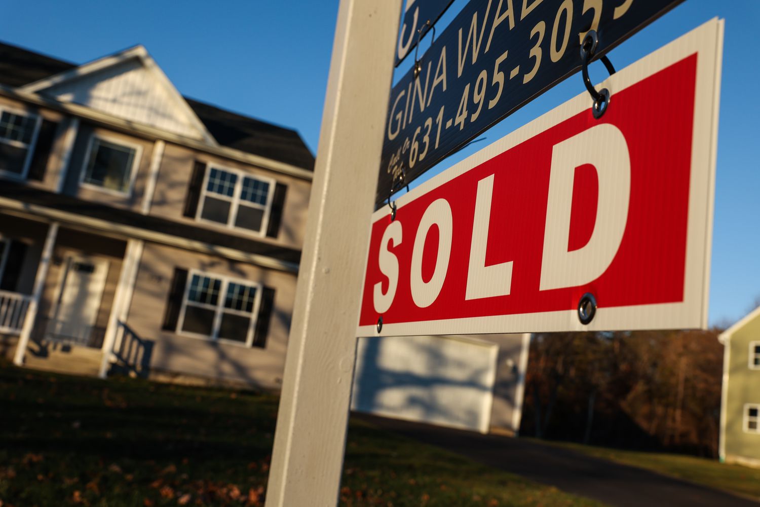 A "sold" sign in front of a Long Island, NY home.
