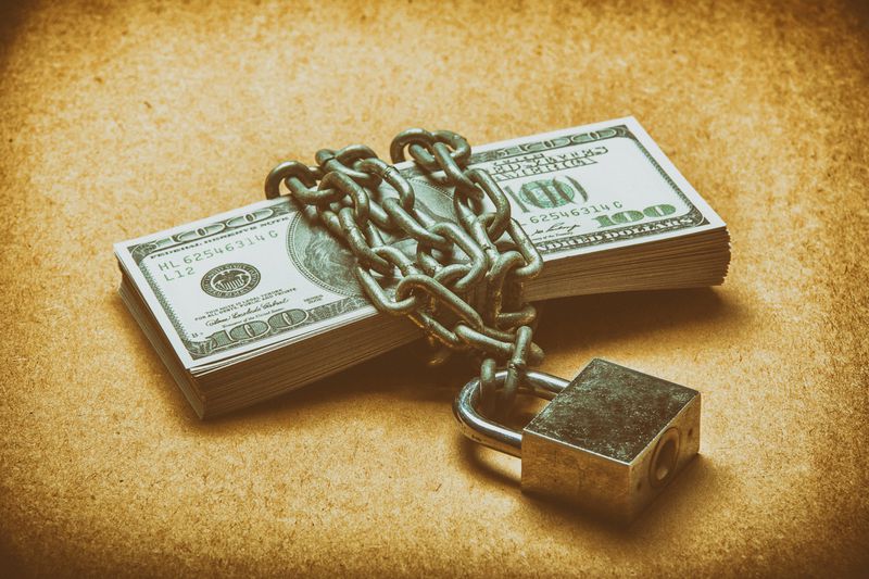 Hundred dollar bills wrapped in chains