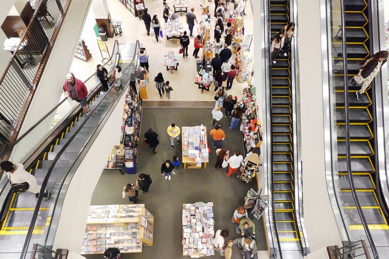 Shoppers in a store with escalators