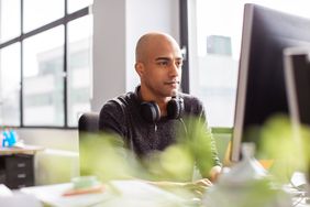 A man reading how Investopedia reviewed and rated the best crypto software wallets