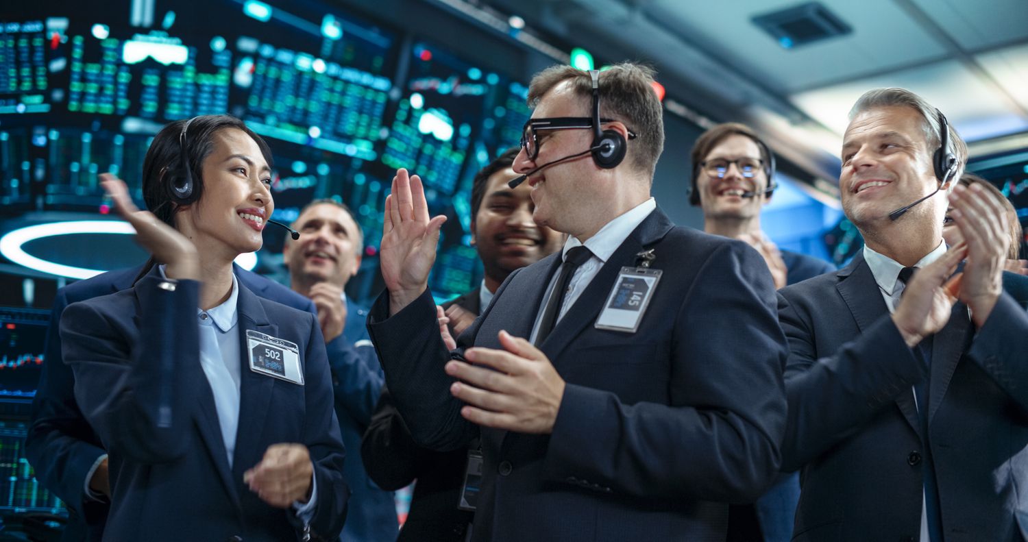 Professional brokerage traders congratulate each other after completing the execution of a large step-out trade.