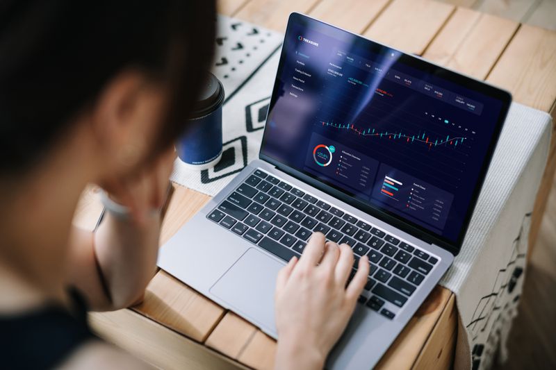 Person on a computer looking at a graph of stock market data