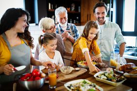 Grandparents, parents and children spending happy time in the kitchen. 
