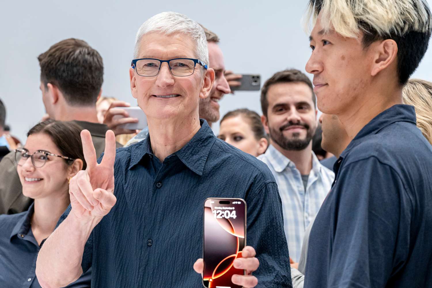 Apple CEO Tim Cook holds an iPhone 16 Pro Max at an event at the company's headquarters in Cupertino, California.