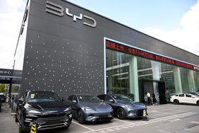 A group of black and silver electric vehicle sit outside a BYD store in China.