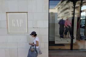 People walk past a Gap store on November 21, 2024 in Miami Beach, Florida