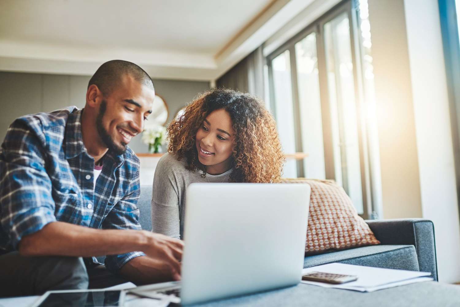 Couple at home looking at investments on laptop