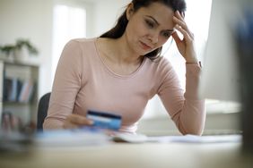 Woman reading about the basics of her credit card