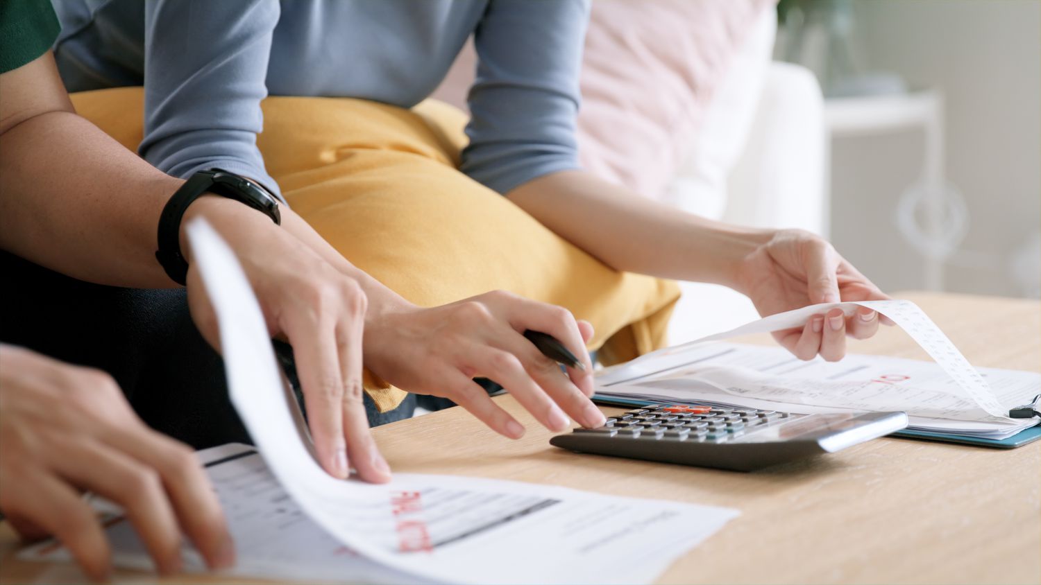 Couple discussing a past-due notice with a calculator