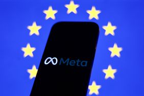 The Meta logo is seen on a phone screen in front of a European Union flag.