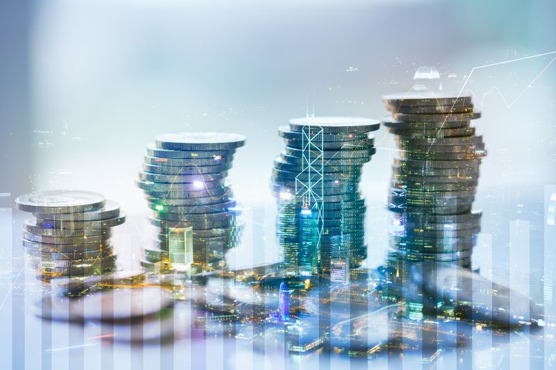 Rising coins overlaid with charts and graphs