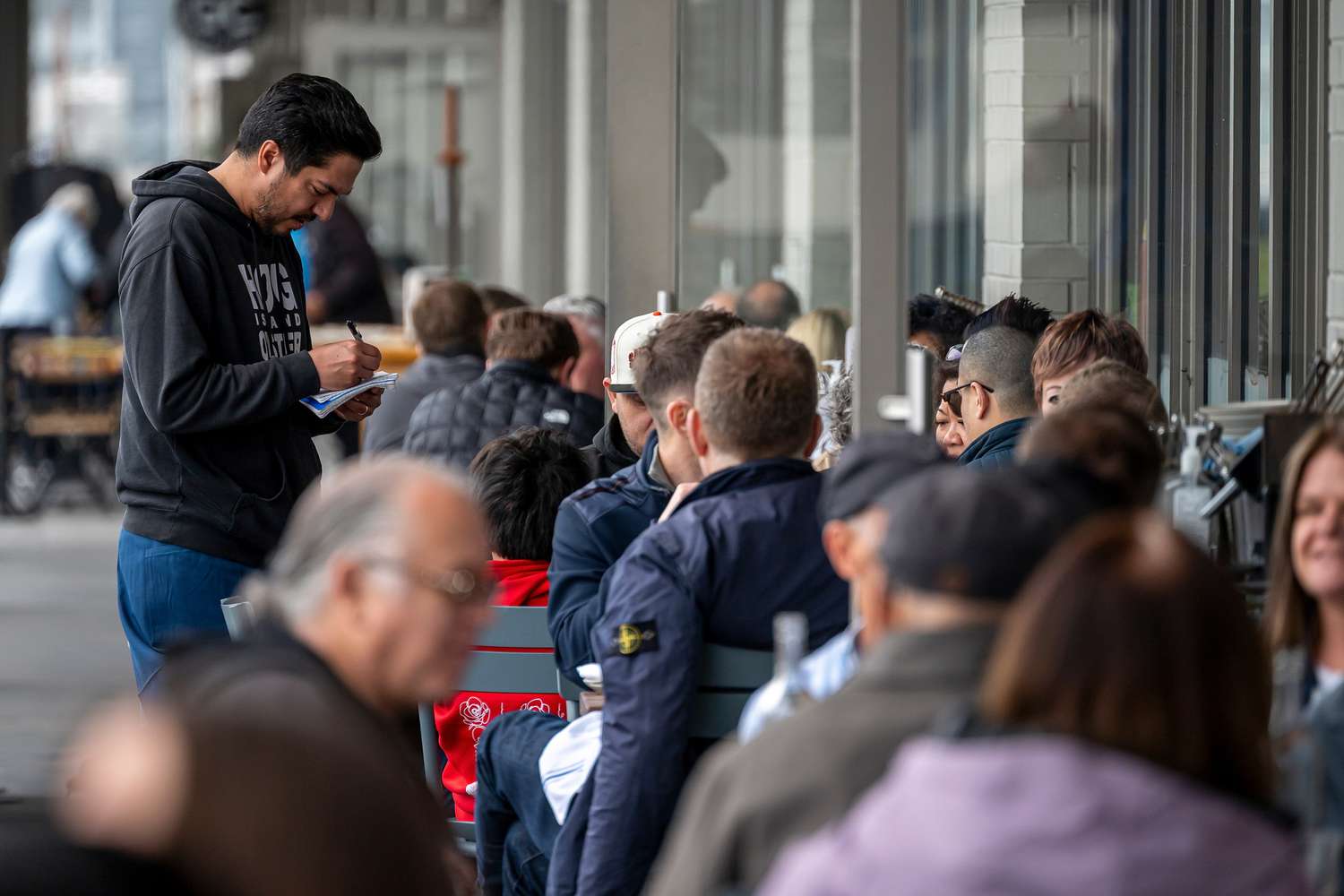 A server takes an order at a restaurant in the Ferry Building in San Francisco, California, US, on Thursday, March 27, 2025