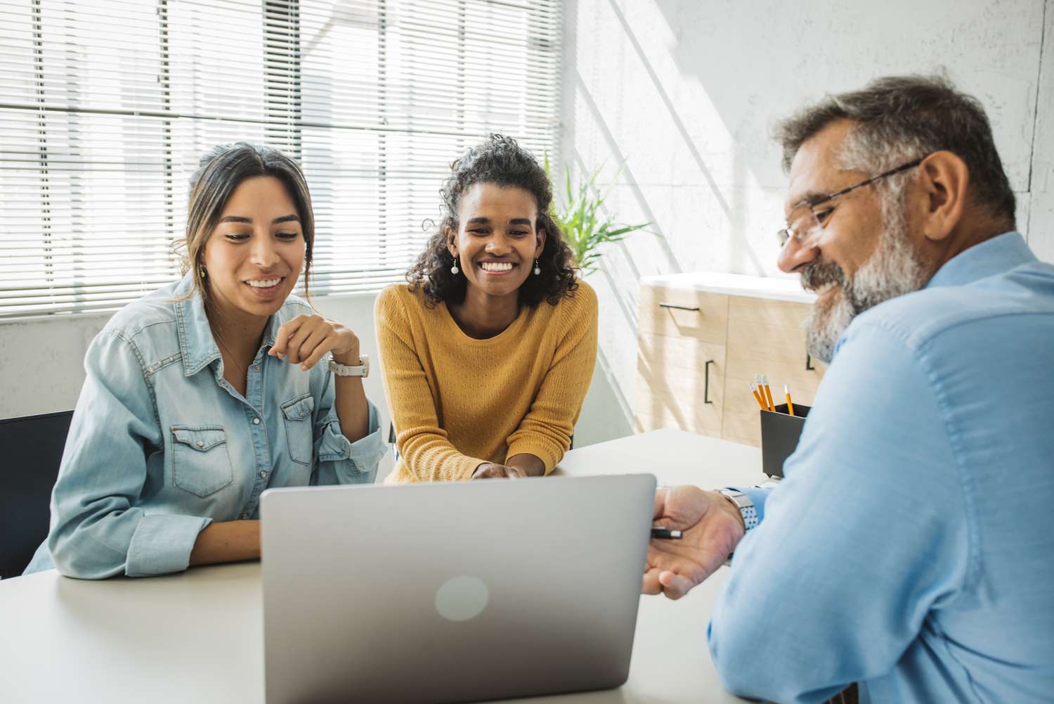 Female gay couple with financial agent at office