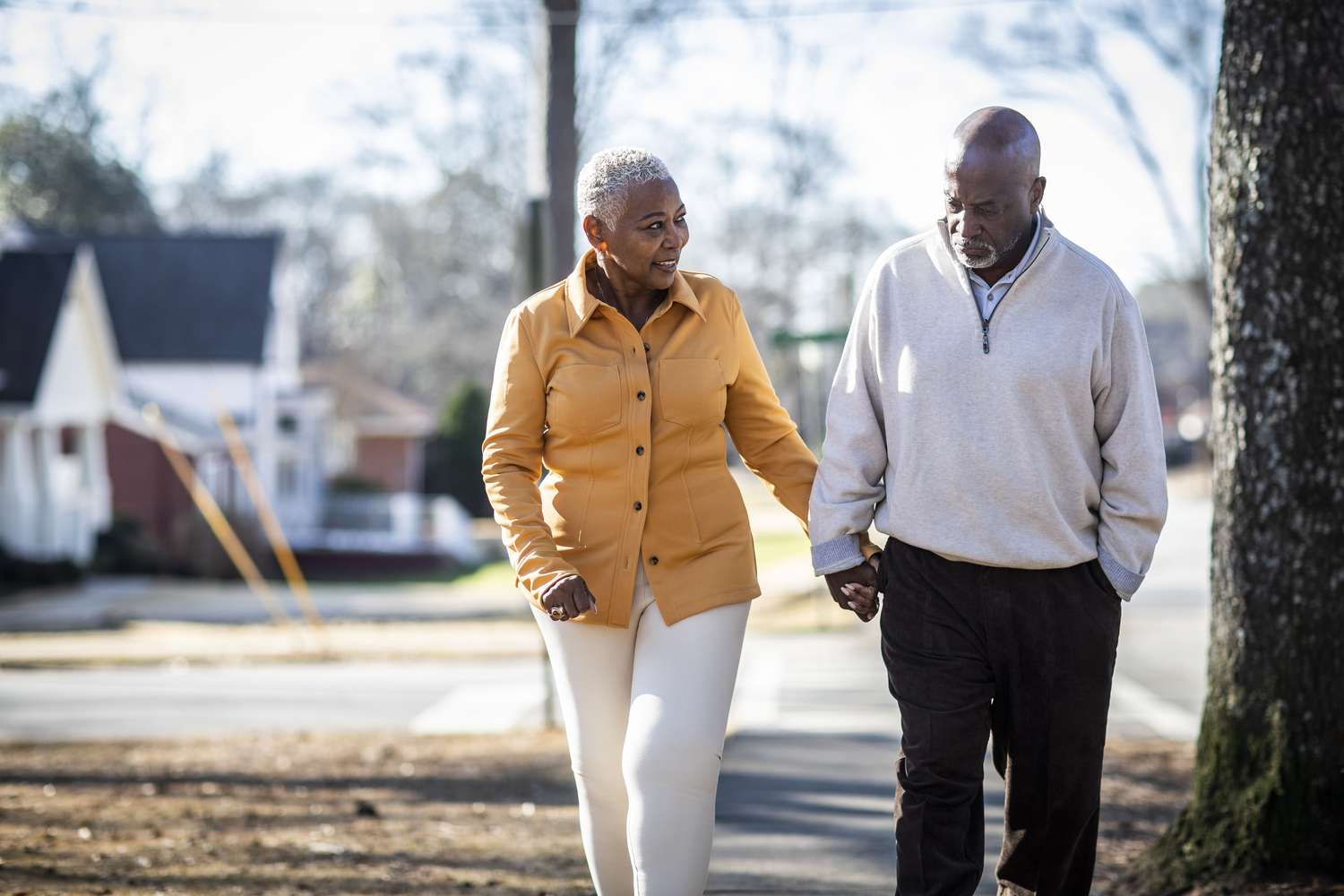 A couple takes a walk in a neighborhood