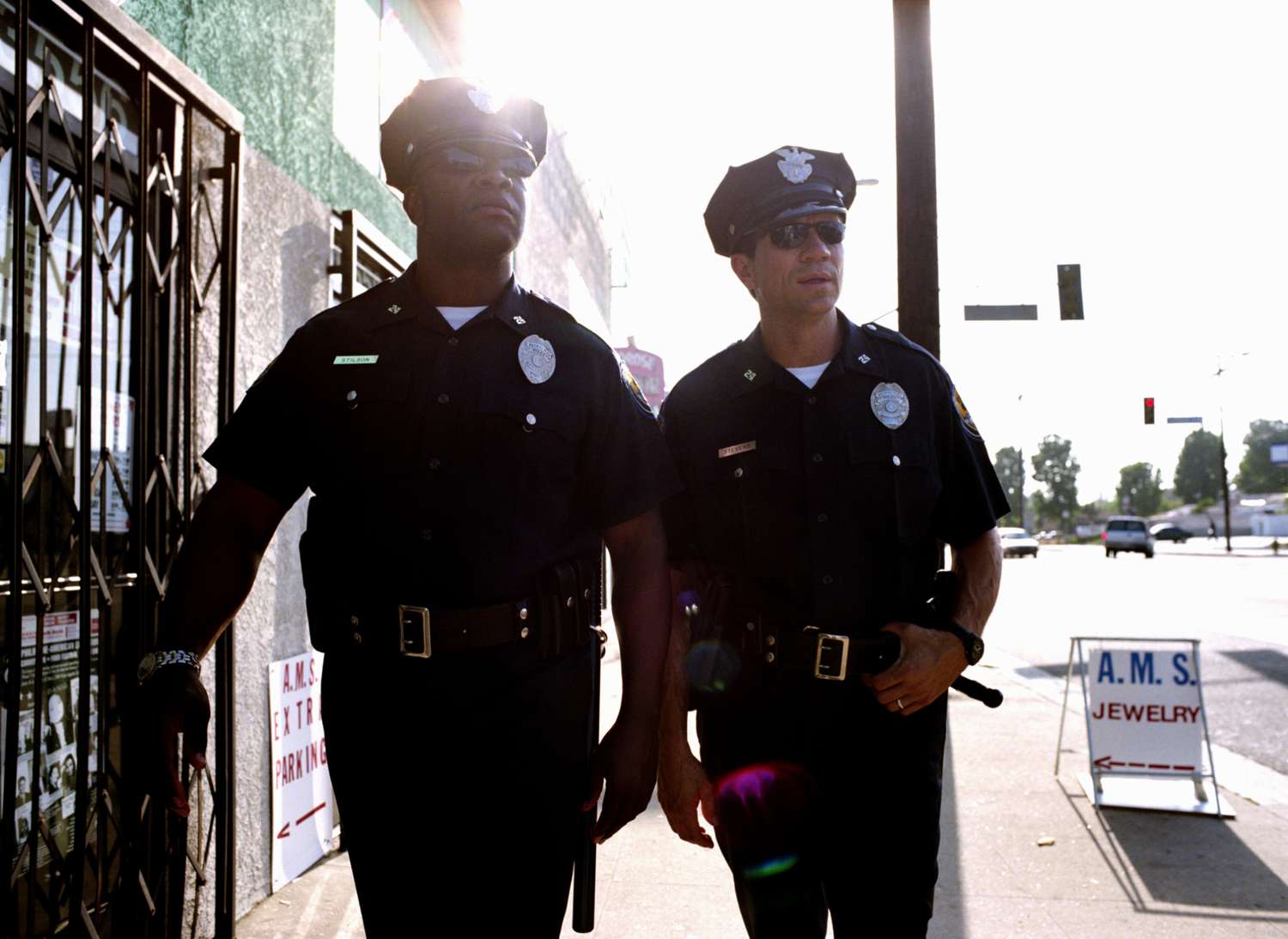 Two policemen walking down the sidewalk