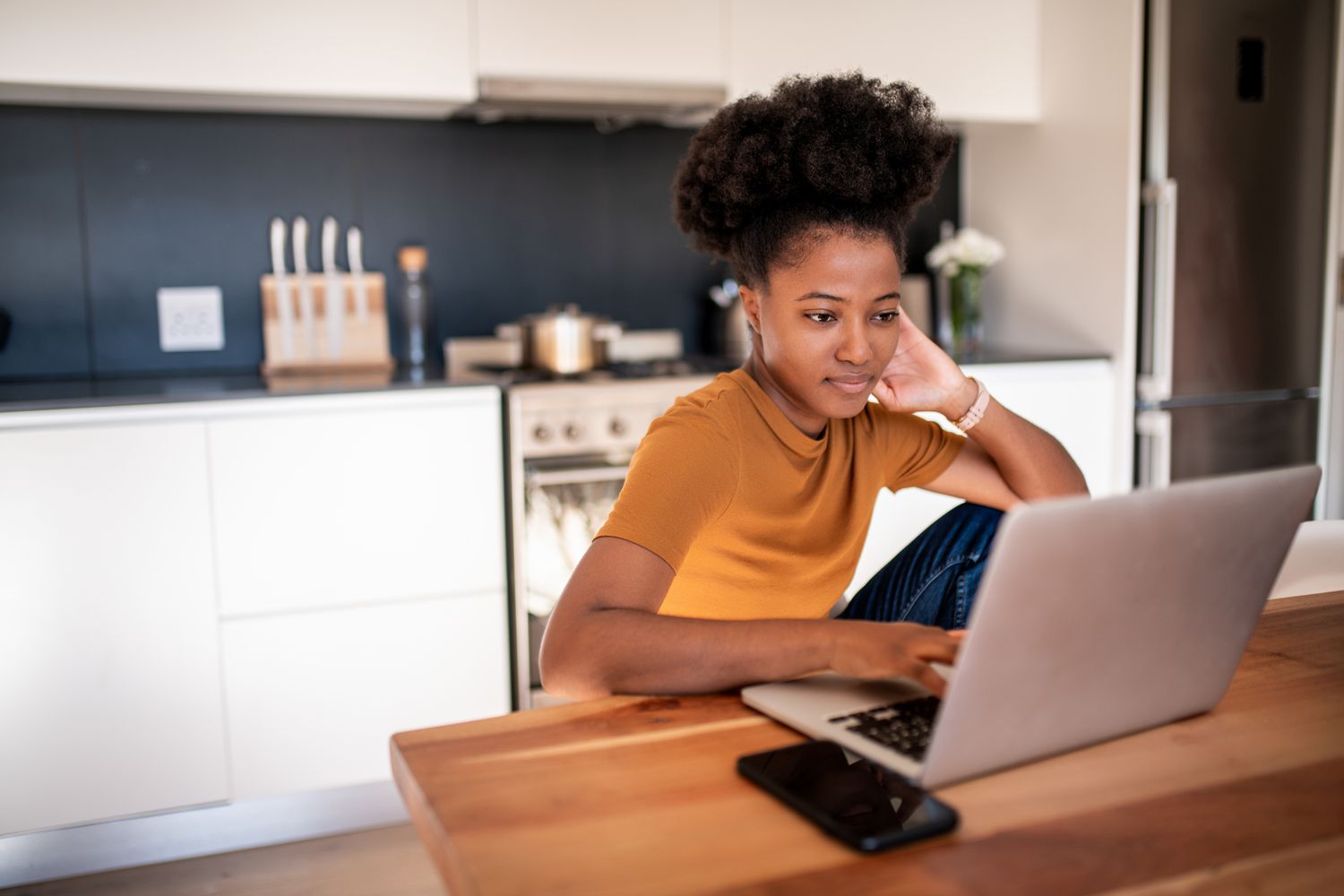 Woman reading about budgeting strategies ahead of student loan payments resuming 