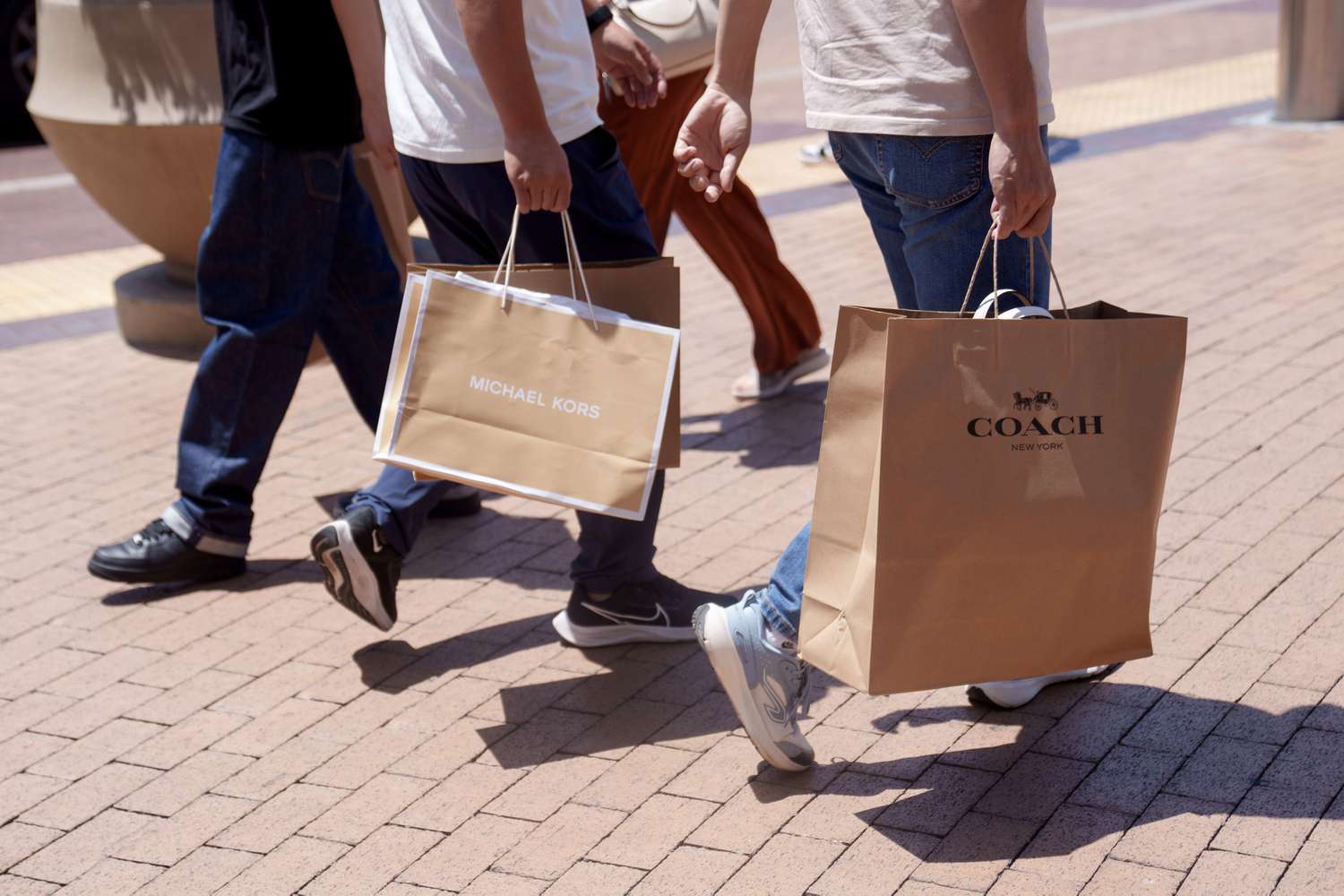Shoppers carry bags at an outlet mall in California. 
