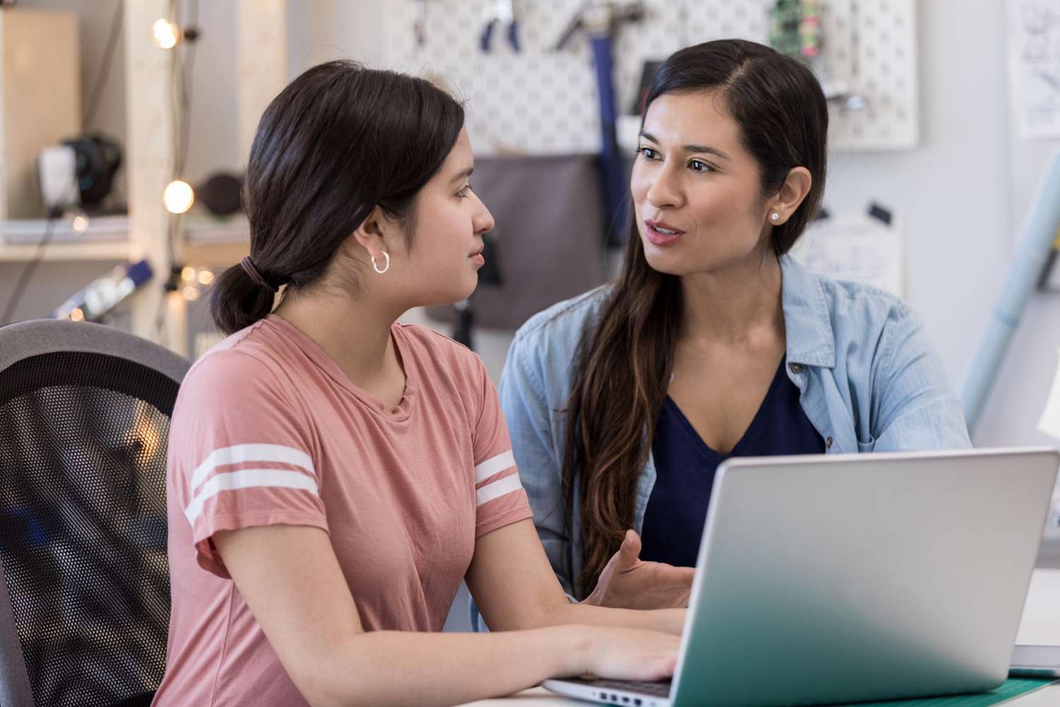 Divorced parent looking up on her computer how to get financial aid for her child