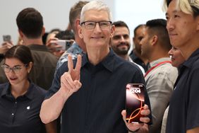 Apple CEO Tim Cook displays the new iPhone 16 during an Apple special event at Apple headquarters on September 09, 2024 in Cupertino, California.