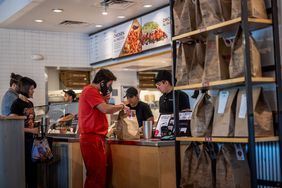 People order food at a Chipotle restaurant. 