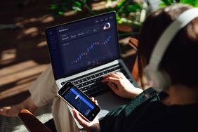 Woman managing finance with online banking. Investment and trading.
