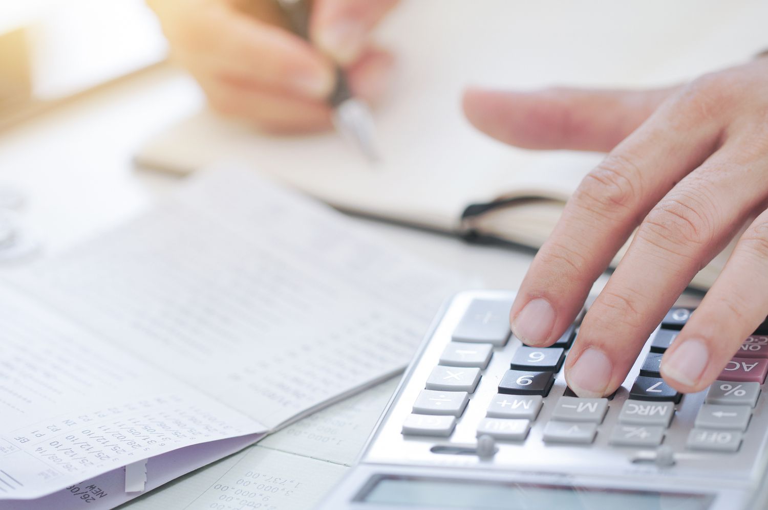An accountant hand using a calculator.