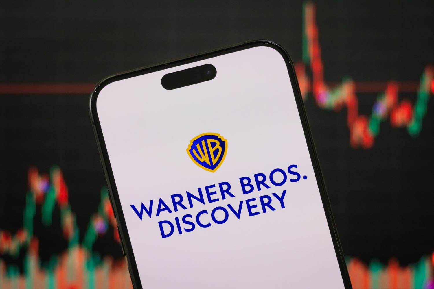 Warner Bros. Discovery logo is displayed on a smartphone screen