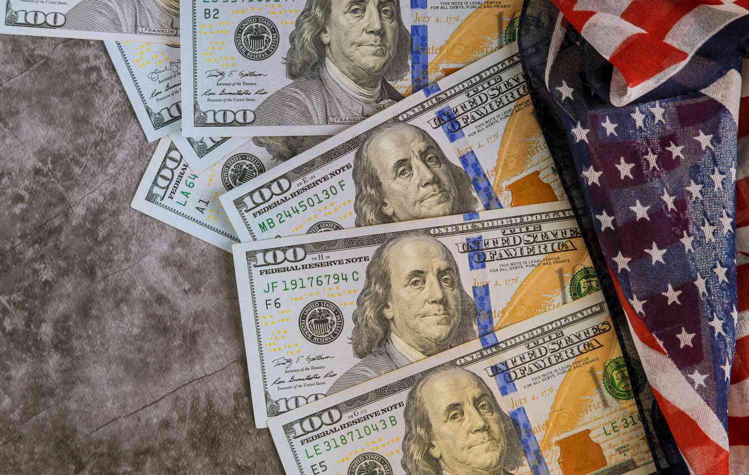 US one hundred dollar bills with an American flag.