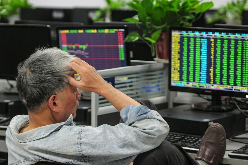 Investor looking with dismay at his positions on monitor