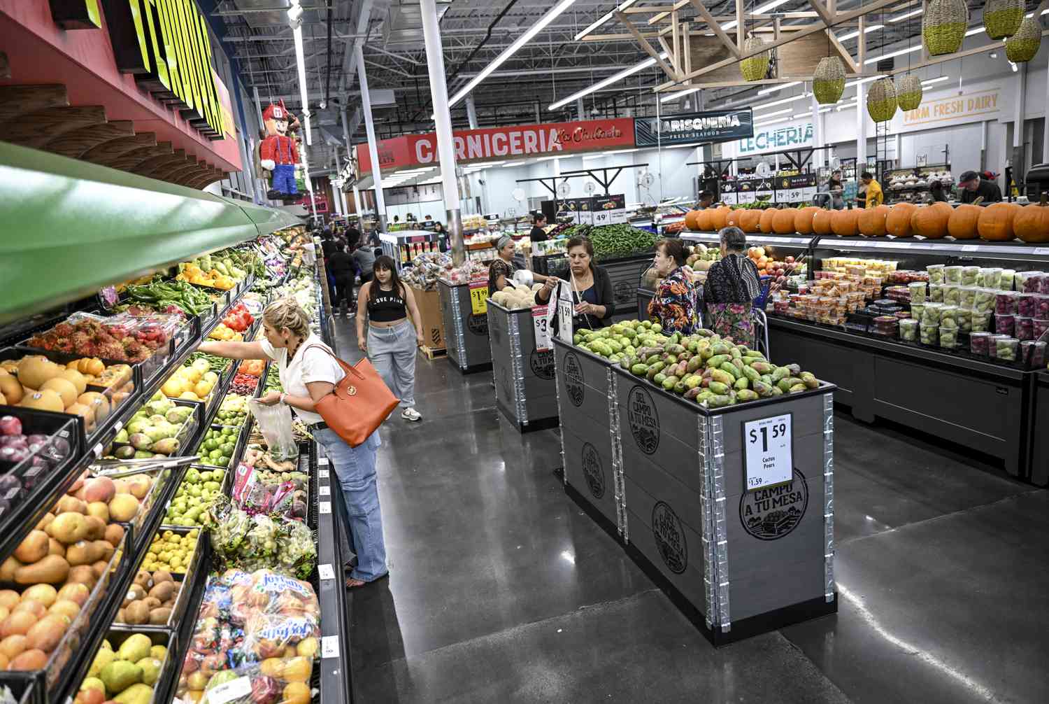 Customers shop at Ahorra Mucho in Aurora, Colorado on Tuesday, October 23, 2024. 