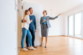 Real Estate Agent showing house to a young couple from a rental listing site