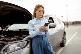 Woman with vehicle engine problem or accident and emergency help from a professional mechanic