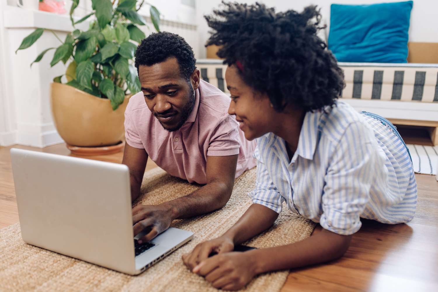 A young couple reviews financial options on their laptop