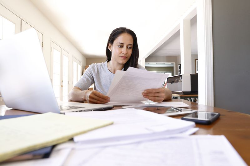 Woman doing paperwork at a table